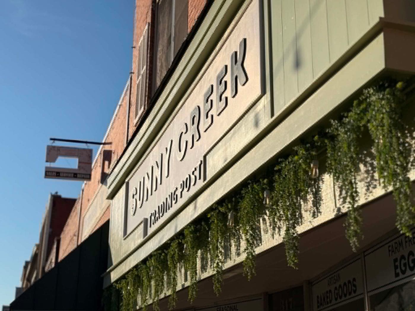 The Sunny Creek Trading Post storefront sign on E. Grand Ave. in downtown Ponca City